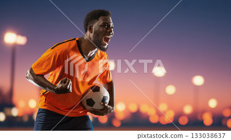 Excited soccer player holding ball under night city lights. Handmade collage Excited soccer player holding ball under night city lights. Handmade collage 133038637
