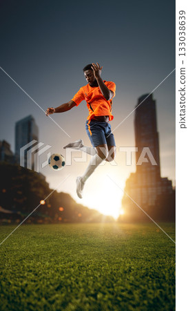 Soccer player jumping midair hitting ball at sunrise. Handmade collage 133038639