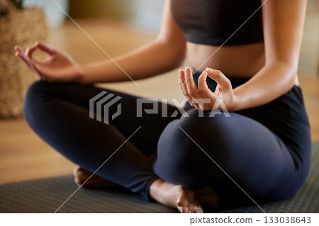 Hands, lotus pose and woman on a floor for yoga, mediation and zen in her living room. Hand, girl and meditation for fitness, peace and balance, chakra and energy training, spiritual and healing Hands, lotus pose and woman on a floor for yoga, mediation and zen in her living room. Hand, girl and meditation for fitness, peace and balance, chakra and energy training, spiritual and healing 133038643