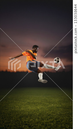 Soccer player jumping kick at sunset on field. Handmade collage 133038644