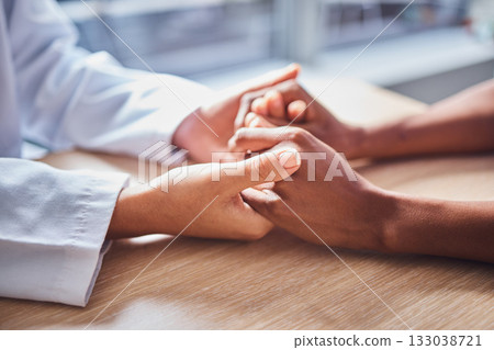 Holding hands, cancer and doctor in support of patient for comfort, trust and help in a hospital or clinic office. Closeup, care and healthcare professional consulting a person for medical advice Holding hands, cancer and doctor in support of patient for comfort, trust and help in a hospital or clinic office. Closeup, care and healthcare professional consulting a person for medical advice 133038721