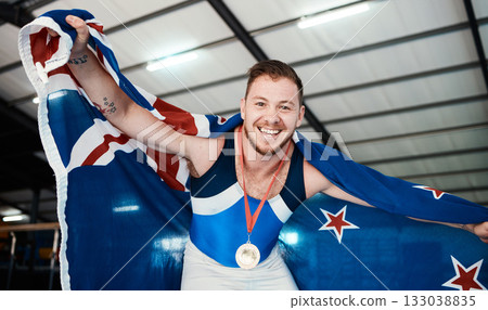 Win, gymnastics and portrait of a man with a flag for sports, achievement and celebration. Happy, celebrate and athlete gymnast with a smile for winning, medal and award for sport competition Win, gymnastics and portrait of a man with a flag for sports, achievement and celebration. Happy, celebrate and athlete gymnast with a smile for winning, medal and award for sport competition 133038835