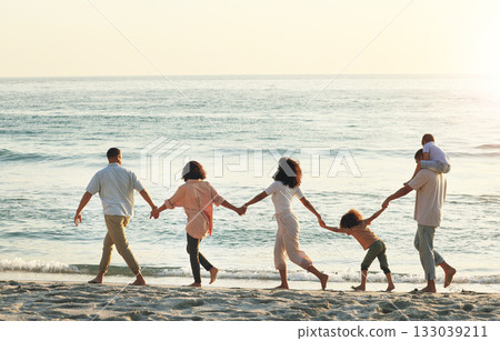 Big family, walking and holding hands at beach at sunset, having fun and bonding on vacation outdoors. Care, mockup and kids, grandmother and grandfather with mother and father enjoying holiday time 133039211
