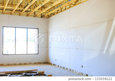 Construction progress of new home interior showing unfinished drywall framing work Construction progress of new home interior showing unfinished drywall framing work 133039222