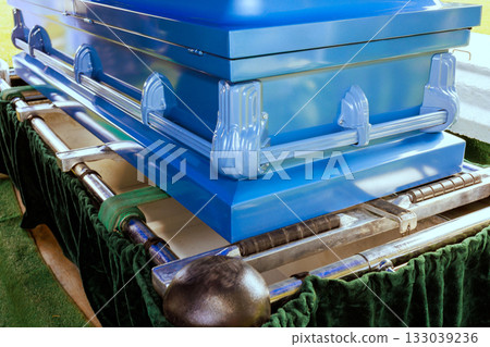 Coffin resting on green velvet at burial site during solemn farewell in cemetery Coffin resting on green velvet at burial site during solemn farewell in cemetery 133039236