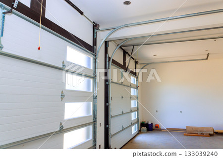 Spacious garage interior with modern design abundant natural light for vehicle storage workspace Spacious garage interior with modern design abundant natural light for vehicle storage workspace 133039240