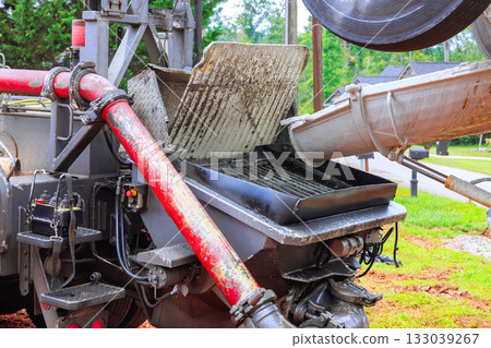 Heavy machinery used for industrial construction work on site during daylight hours in suburban area Heavy machinery used for industrial construction work on site during daylight hours in suburban area 133039267