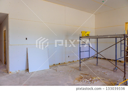 Room under construction with drywall scaffolding at residential building site 133039336