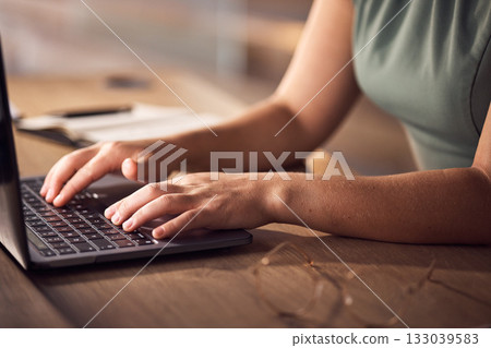 Business woman, hands or laptop typing in night office for company budget, investment management or finance data analytics. Zoom, worker or late employee on technology keyboard for financial report Business woman, hands or laptop typing in night office for company budget, investment management or finance data analytics. Zoom, worker or late employee on technology keyboard for financial report 133039583