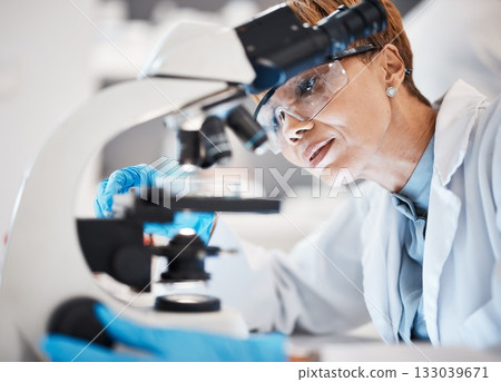 Medical science, woman and microscope in a laboratory for research, analytics and to study particle. Scientist person with glasses for dna or bacteria in lab for innovation, future and biotechnology 133039671