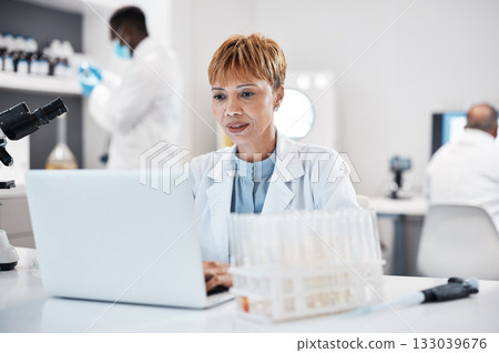 Science, healthcare and scientist with a laptop for research, innovation and pharmaceutical email. Lab, pharmacy and mature woman reading results of virus on a computer for analysis and breakthrough 133039676