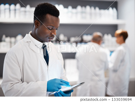 Science, black man and tablet with research, chemist and connection for typing, laboratory and focus. African American male employee, researcher and scientist with device, future or telehealth in lab Science, black man and tablet with research, chemist and connection for typing, laboratory and focus. African American male employee, researcher and scientist with device, future or telehealth in lab 133039694