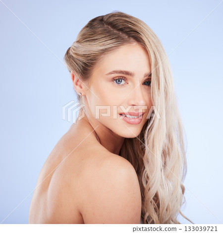 Beauty, hair care and face portrait of woman in studio isolated on a blue background. Cosmetics, keratin and happy young female model with salon treatment for hairstyle, blonde balayage and growth. Beauty, hair care and face portrait of woman in studio isolated on a blue background. Cosmetics, keratin and happy young female model with salon treatment for hairstyle, blonde balayage and growth. 133039721