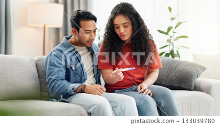 Pregnancy test, home and couple waiting on sofa unsure for fertility doubt, results and parenting news. Relationship, pregnant and man with woman with medical kit for ivf treatment or ovulation 133039780