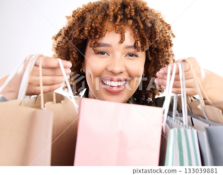 Shopping, portrait or happy black woman with bags from boutique sale isolated on white background. Smile, face or excited customer studio with market products on discount or retail offer in studio Shopping, portrait or happy black woman with bags from boutique sale isolated on white background. Smile, face or excited customer studio with market products on discount or retail offer in studio 133039881