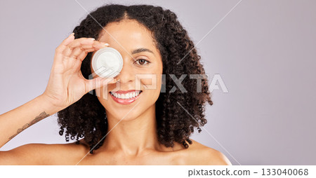 Face, skincare and black woman with cream container in studio isolated on a gray background. Dermatology portrait, cosmetics and happy female model with lotion, creme or moisturizer for skin health. 133040068