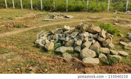 Rock pile in grassy terrain with scattered stones and path Rock pile in grassy terrain with scattered stones and path 133040210