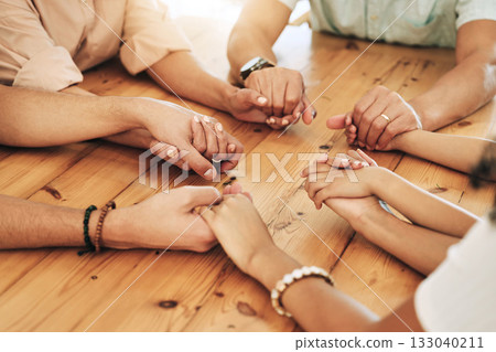 Holding hands, praying and support by group of people or family together in unity, spiritual and faith in God and gratitude. Closeup, Solidarity, religion and hope in a home due to grief 133040211