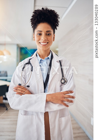 Portrait, black woman and doctor arms crossed, healthcare and smile in hospital, leader and confident. Face, African American female surgeon, employee or medical professional with skills or happiness 133040289