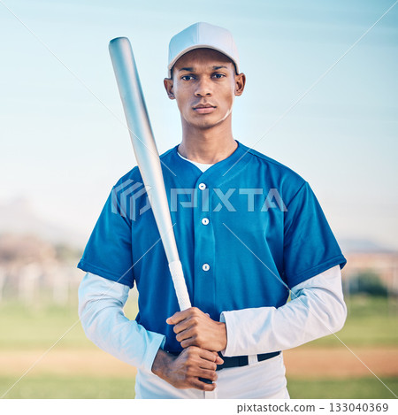 Portrait, baseball and bat with a sports black man outdoor on a field standing ready to play a competitive game. Fitness, exercise and training with a serious male athlete outside at a sport stadium Portrait, baseball and bat with a sports black man outdoor on a field standing ready to play a competitive game. Fitness, exercise and training with a serious male athlete outside at a sport stadium 133040369