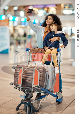 Travel, selfie and mother and daughter in airport for social media, holiday trip and global journey. Smile, luggage and phone with black woman and child picture for vacation, departure and tourism Travel, selfie and mother and daughter in airport for social media, holiday trip and global journey. Smile, luggage and phone with black woman and child picture for vacation, departure and tourism 133040623