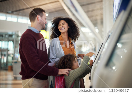 Self service, travel and interracial with family in airport for check in, vacation and global. Technology, digital and smile with parents and child for holiday, flight and ticket information Self service, travel and interracial with family in airport for check in, vacation and global. Technology, digital and smile with parents and child for holiday, flight and ticket information 133040627