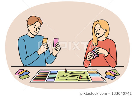 Happy couple playing board game while spending free time together and having fun after working day Happy couple playing board game while spending free time together and having fun after working day 133040741