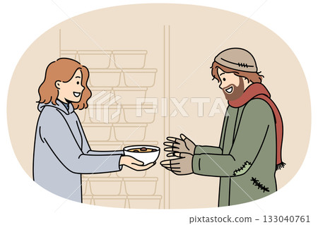 Woman volunteer feeds homeless man who came to shelter for help and hot meals, standing near plates 133040761