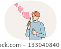Romantic man uses heart-shaped soap bubbles to show love and kindness to people around him 133040840