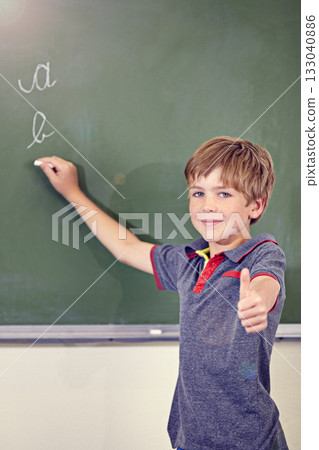 Portrait, child writing and thumbs up on blackboard in classroom, elementary school and mockup. Chalkboard, education student and kid with hand gesture for like emoji, agreement and learning to write 133040886