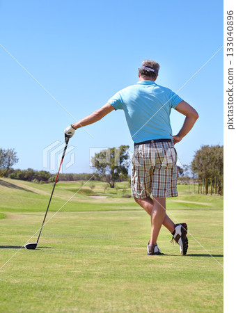 Golf, rear view and old man with driver outdoor for training, hobby and sports on blue sky background. Club, behind and active senior male golfer on field for retirement fitness, match or practice 133040896