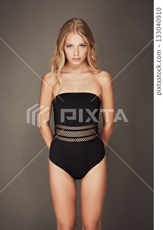Fashion, bodysuit and portrait of a woman in underwear for fashion, slim body and sexy style. Aesthetic female model with natural glow, lingerie or swimwear and serious face on a grey background Fashion, bodysuit and portrait of a woman in underwear for fashion, slim body and sexy style. Aesthetic female model with natural glow, lingerie or swimwear and serious face on a grey background 133040910