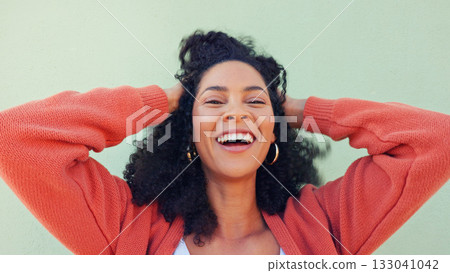 Woman, portrait and happy with hair or play at wall for beauty or energy, curly treatment or wellness. Black person, natural, and smile for cosmetic care or hands in excitement for healthy results 133041042