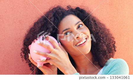 Piggy bank, savings and face of woman with money, investment or profit check on orange background. Cash, budget and curious lady with money, box or container for future, planning or financial freedom Piggy bank, savings and face of woman with money, investment or profit check on orange background. Cash, budget and curious lady with money, box or container for future, planning or financial freedom 133041061