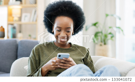 Phone, black woman and typing on sofa in home, reading social media notification and update subscription app. Smile, smartphone and download mobile games, search digital network and online contact 133041072