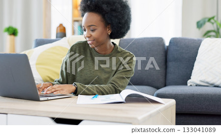 Smile, typing and black woman on laptop in home living room at table, research info and remote work. Happy African freelancer on computer in lounge, planning project and reading email on internet 133041089