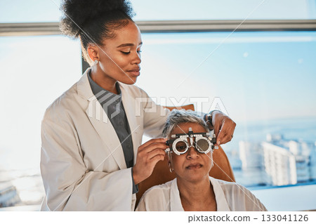 Senior eye exam, black woman doctor and medical eyes test of elderly female at consultation. Vision, healthcare focus and old patient with consulting wellness expert for lens and glasses check 133041126