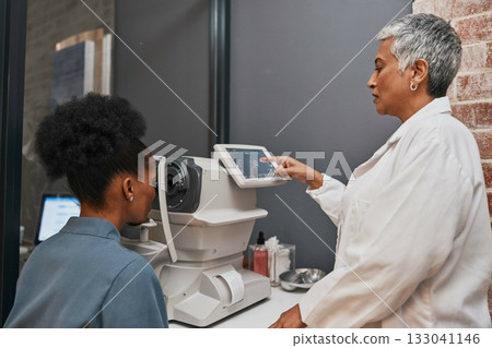Digital eye exam, vision and health for eyes, optometry and doctor with patient, eyecare and ophthalmology clinic. Machine, screen and black woman with senior optometrist, service and medical exam Digital eye exam, vision and health for eyes, optometry and doctor with patient, eyecare and ophthalmology clinic. Machine, screen and black woman with senior optometrist, service and medical exam 133041146