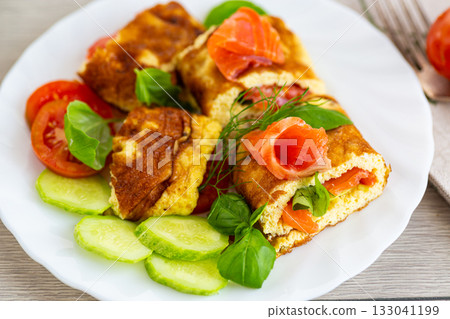 Homemade omelet with red fish and fresh spinach Homemade omelet with red fish and fresh spinach 133041199