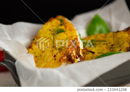 Oven roasted cabbage wedges with flavorful golden coating 133041206