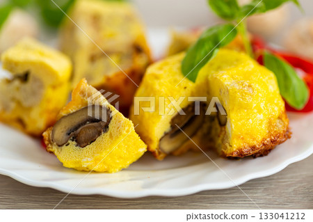 Delicious golden omelet with mushrooms and cauliflower pieces Delicious golden omelet with mushrooms and cauliflower pieces 133041212