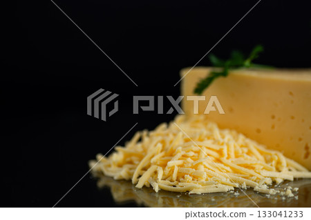 Closeup of grated yellow cheese with parsley leaves macro 133041233