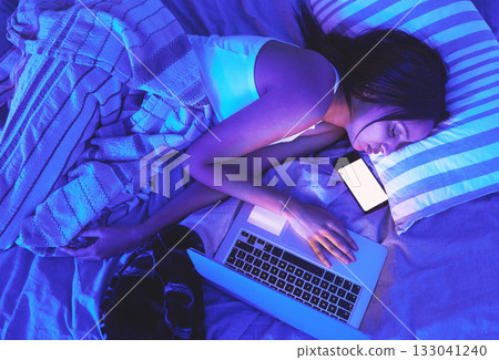 Woman, night and technology while sleeping in home bed with light from laptop and phone in bedroom. Tired student person with burnout asleep online for remote work or mockup social media chat on top Woman, night and technology while sleeping in home bed with light from laptop and phone in bedroom. Tired student person with burnout asleep online for remote work or mockup social media chat on top 133041240