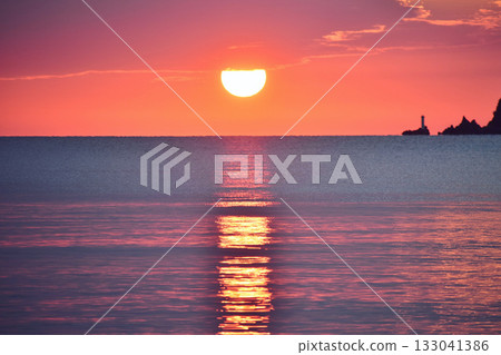 夕陽從厚厚的雲層中緩緩升起。 夕陽從厚厚的雲層中緩緩升起。 133041386