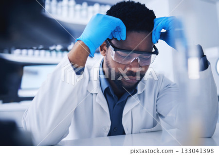 Tired, stress and scientist black man with a fail research in a lab or laboratory frustrated and sad feeling overworked. Exhausted, burnout and tired technician suffering with a headache and fatigue Tired, stress and scientist black man with a fail research in a lab or laboratory frustrated and sad feeling overworked. Exhausted, burnout and tired technician suffering with a headache and fatigue 133041398