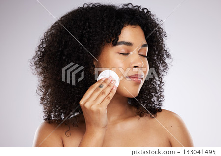 Beauty, cotton swab and face of black woman for wellness, skincare routine and healthy glow. Dermatology care, luxury spa and girl with pads to remove makeup, cosmetics and facial products in studio 133041495