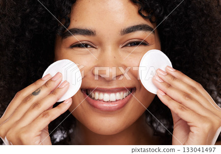 Smile, cotton pad and portrait of black woman for wellness, luxury spa and natural glow in studio. Dermatology, skincare and face zoom of happy girl with swab for makeup, cosmetic and facial cleaning Smile, cotton pad and portrait of black woman for wellness, luxury spa and natural glow in studio. Dermatology, skincare and face zoom of happy girl with swab for makeup, cosmetic and facial cleaning 133041497
