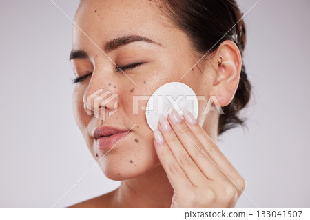 Skincare cotton, face and woman with eyes closed in studio isolated on gray background. Makeup hygiene, beauty aesthetics and closeup of female model with facial pad or product for cleaning cosmetics Skincare cotton, face and woman with eyes closed in studio isolated on gray background. Makeup hygiene, beauty aesthetics and closeup of female model with facial pad or product for cleaning cosmetics 133041507