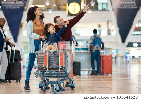 Pointing, travel and interracial family at the airport looking at a departure time for a flight. Happy, trip and parents with a child to look at information for arrival or leaving of an airplane Pointing, travel and interracial family at the airport looking at a departure time for a flight. Happy, trip and parents with a child to look at information for arrival or leaving of an airplane 133041528