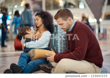 Phone, tired and interracial family waiting at the airport for a delayed flight. Contact, late and man on a mobile app with a black woman and child sleeping during problems with travel on a trip Phone, tired and interracial family waiting at the airport for a delayed flight. Contact, late and man on a mobile app with a black woman and child sleeping during problems with travel on a trip 133041535